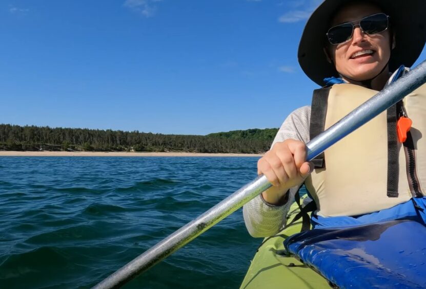 Woman kayaking in full safety gear