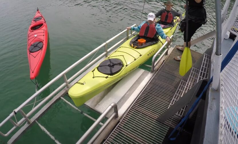 Kayakers at a launch point boat